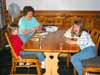 [Sitting round the table]
